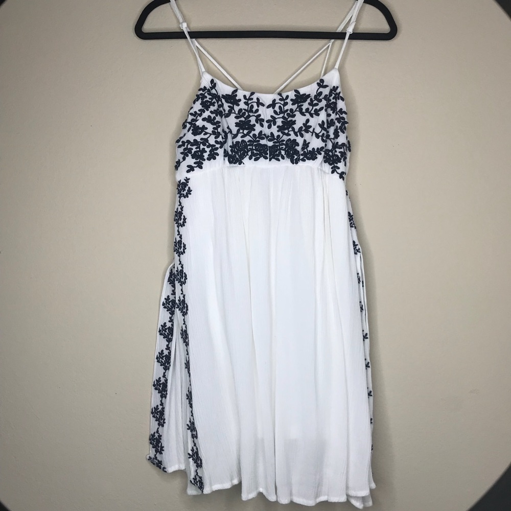 White dress with blue flower embroidery